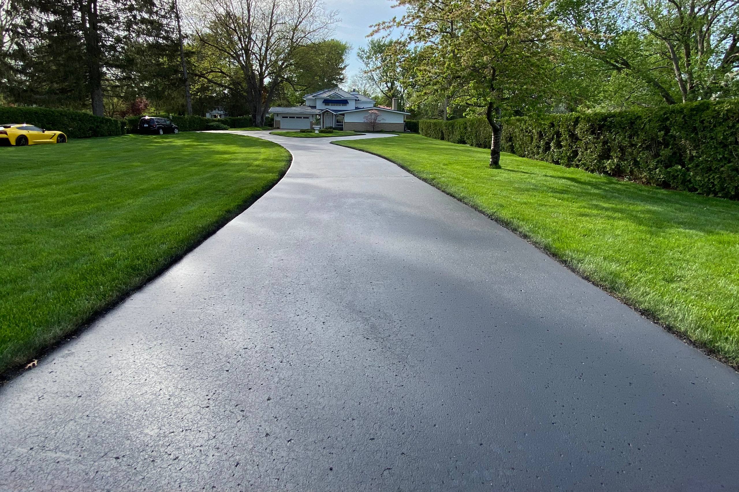 Freshly sealcoated driveway completed by Mason’s Asphalt