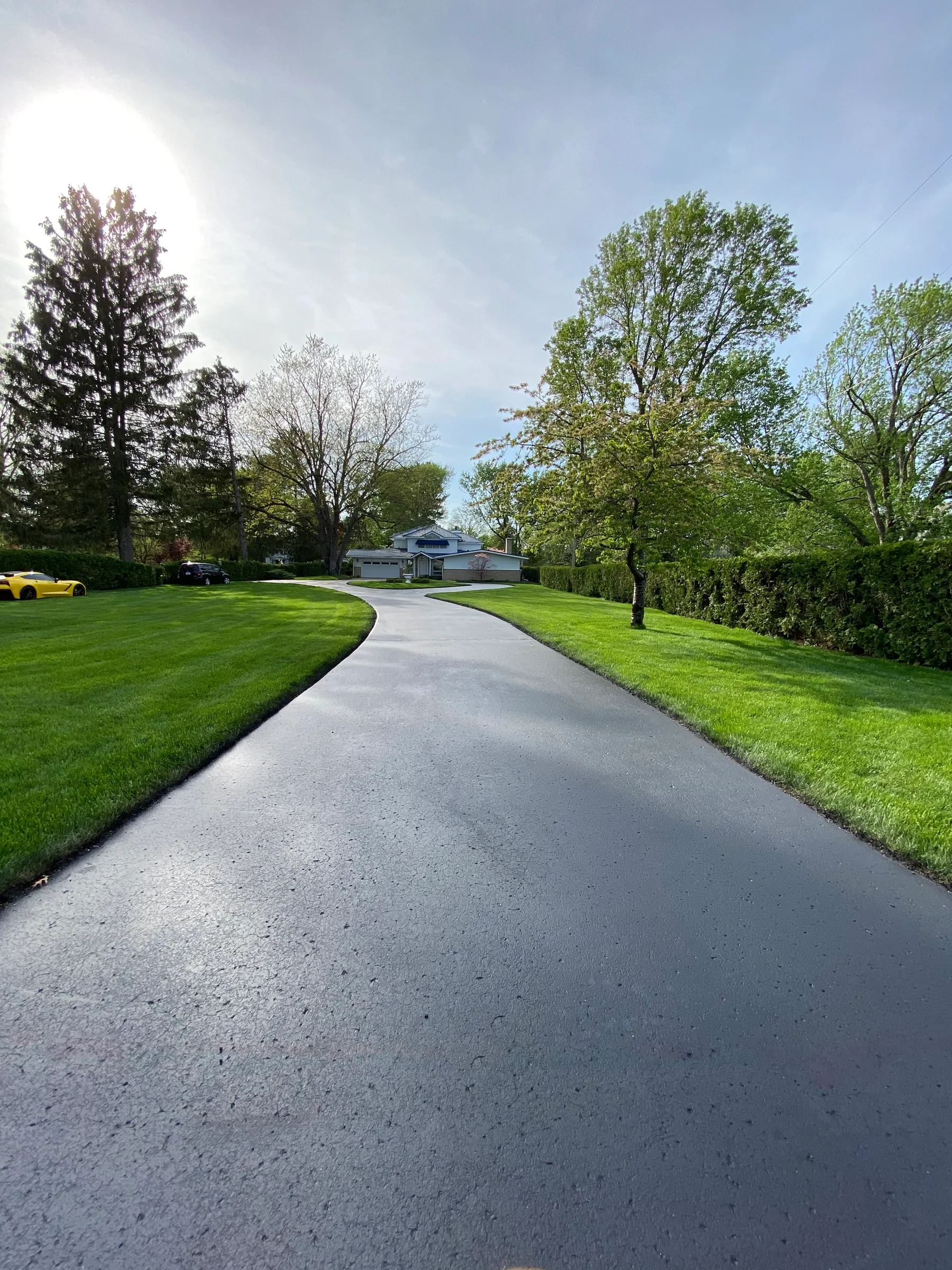 Freshly sealcoated driveway completed by Mason’s Asphalt